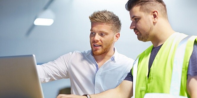 Two experts use the roadway asset management system to plan their team's work.

