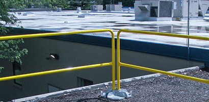 Temporary guardrail system set up on corner of roof
