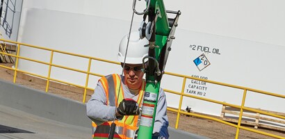 Workers operating winch on vertical retrieval davit
