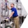 Man working in an engineering workspace with lots of connected pipes.