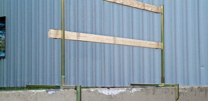 Temporary wooden guardrail attached to concrete walkway
