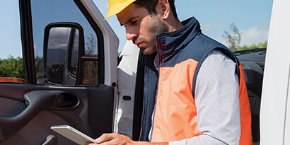 Maintenance crew member uses road and highway assent management software on a tablet in the field.

